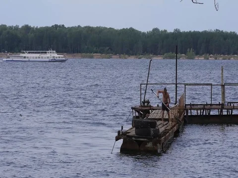 A man with an oar on a river dock Stock Footage 78111021