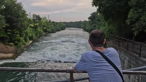 Man Observes Powerful River Flow Stock Footage 280993240