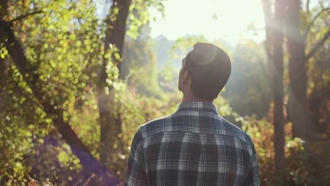 Man Observing Forest During Morning Sunrise (Panning Up) Stock Footage 81491903