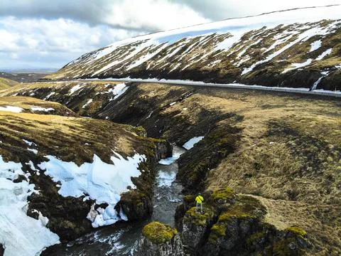 Man observing river next to road in Iceland. Image taken with a drone Stock Photos