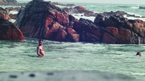 The man in the ocean on the background said Stock Footage 241833891