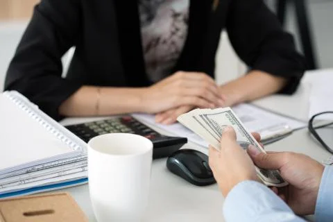 Man offering batch of hundred dollar bills Stock Photos