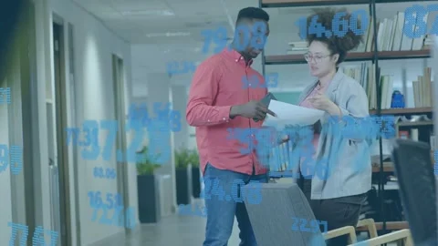 Man offering papers, woman checking tablet, blue data overlay showing figures Stock Footage 335281927