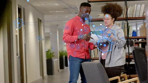 Man offering sheet, woman glancing at tablet and checking printed documents in Video stock 334014053