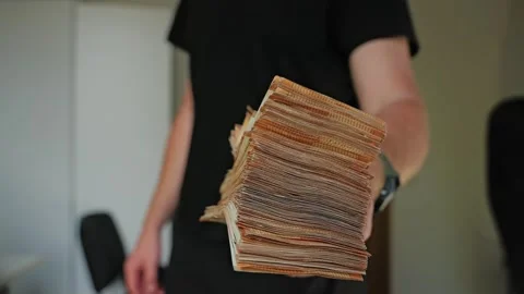 Man Offers Large Stack of Euro Cash to Viewer – Concept of Business Credit Stock Footage 312043986