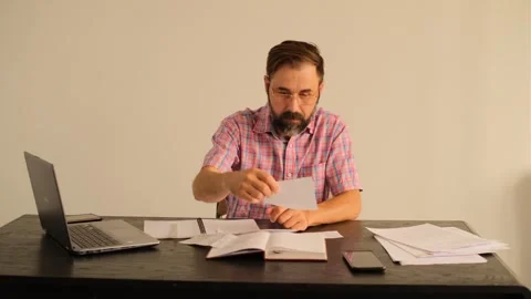 A man in the office cannot deal with documents Video stock 245225103