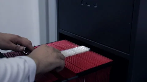 Man at the office checking and searching for a file in file cabinet. Stock Footage 141801242