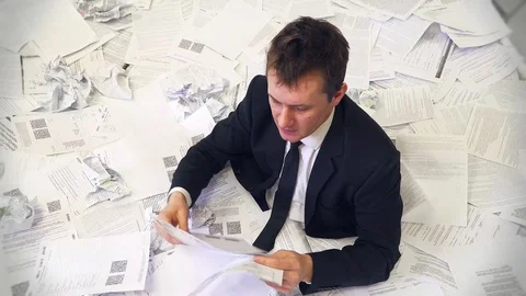 The man in the office drowning in paper Video stock 83822649