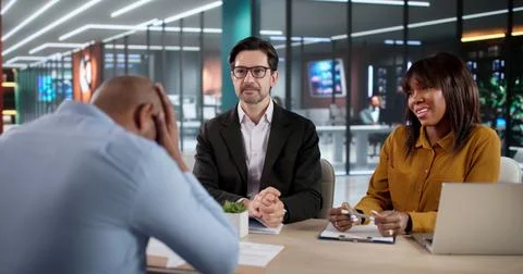 Man In Office During Job Interview Looks Unhappy And Frustrated While Recruit Stock Photos