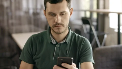 Man in the office looking at the phone Stock Footage 90173052