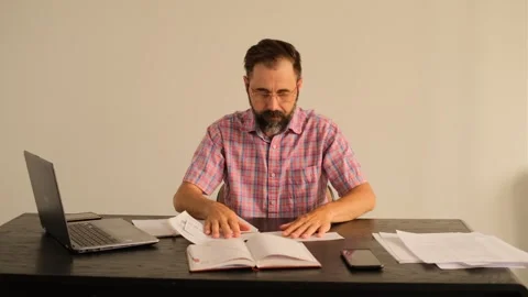 A man in the office looking for the right records Video stock 245225083