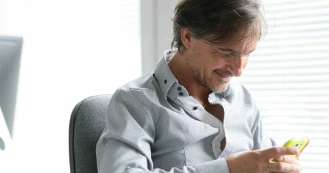 Man in office making a video call by smartphone Stock Footage 114726456