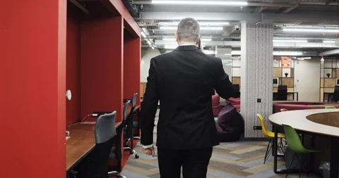 Man office manager talking mobile phone working in modern office, back view. Stock Footage 121843659