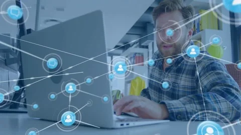Man in office, node appearing over laptop causing network map growth, pointing Stock Footage 334039464