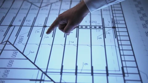 A man in an office points out important details of a diagram on an Stock Footage 317169792