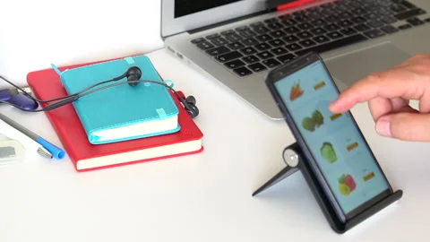 Man In The Office Room Using A Smartphone Shopping In The Online Store. Stockbeeldmateriaal 145664594