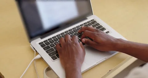 Man in an office typing on a computer Stock Footage 184968568