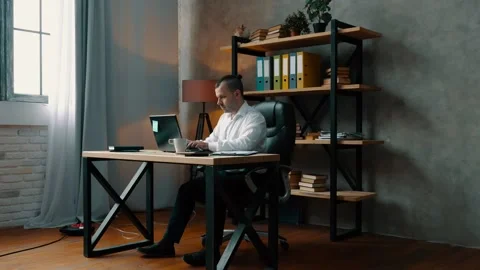 Man in the office is typing on a laptop. Stock Footage 133444589