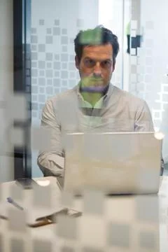 Man in office using laptop computer Stock Photos