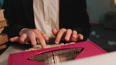 Man in the office using a retro typewriter machine to type some documents. 4k Video stock 135596193