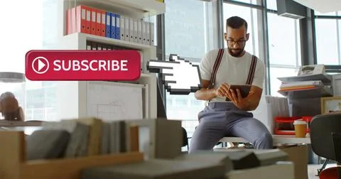 Man in office using tablet, surrounded by files, with subscribe button overlay Stock Photos