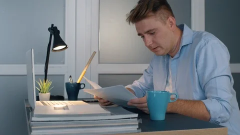 Man in office work hard uses documents and laptop. Slow motion business concept. Stock Footage 116426753