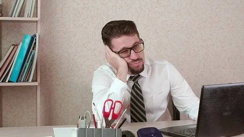 A man office worker with a beard and glasses misses his laptop. Stock Footage 96320962
