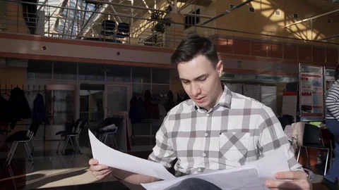 Man office-worker looking in documents inside office Stock Footage 73306990