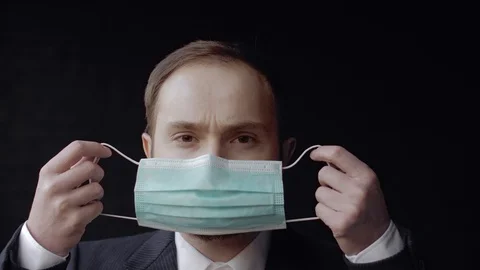 Man, office worker wears protective medical mask during coronavirus quarantine Stock Footage 128376723