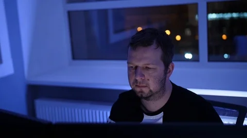Man in office working on computer ay night Stock Footage 86949963