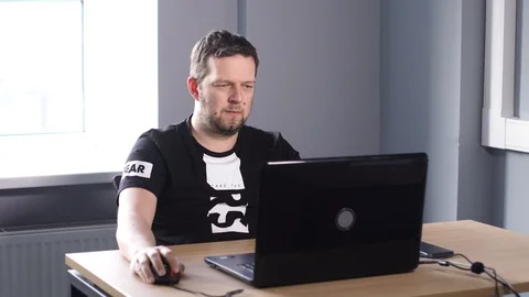 Man in office working on computer Stock Footage 86950099