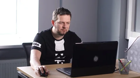 Man in office working on computer good mood Stock Footage 86950074