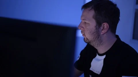 Man in office working on computer at night Stock Footage 86949958