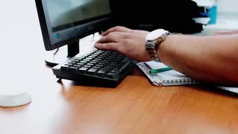 A Man in the office working on a computer. Typing text on keyboard Video stock 156681231