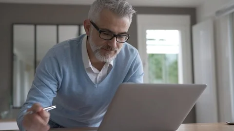 Man in office working on laptop computer Video stock 124066378