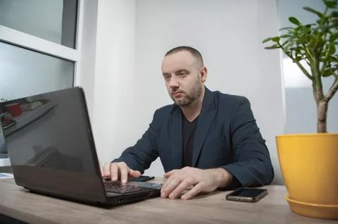 The man in the office works on the computer Stock Photos