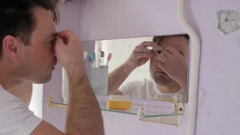 Man in old bathroom Stock Footage 194400129