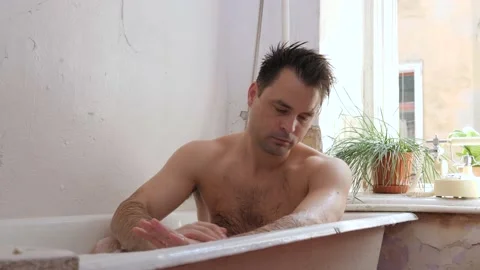 Man in old bathroom Stock Footage 194400415