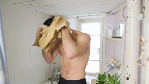 Man in old bathroom Stock Footage 194514597