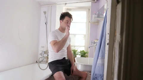 Man in old bathroom Stock Footage 194741532