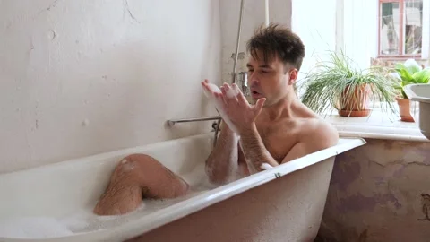 Man in old bathroom Stock Footage 194742077