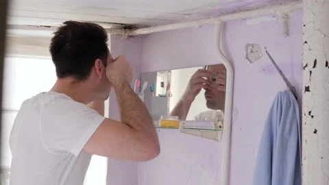 Man in old bathroom Stock Footage 195339215