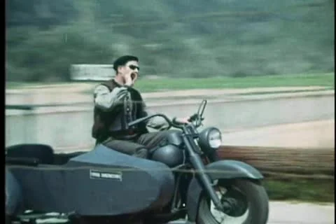 Man on old fashioned motorcycle with sidecar tossing cigarette butt Stock Footage 25207847