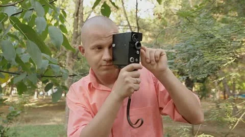 Man with an old film camera Stock Footage 12224353