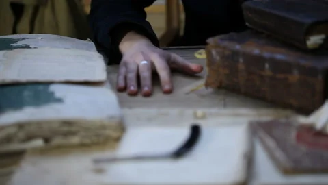Man at old table, around old books and ritual things Video stock 143109957