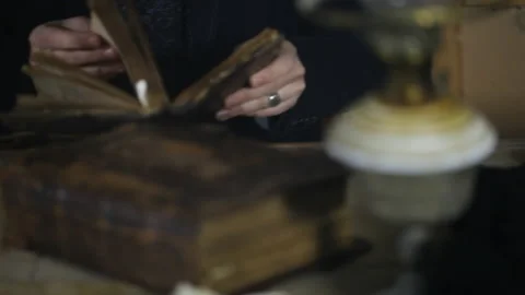 Man at old table, around old books and ritual things Video stock 143109958