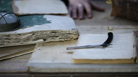 Man at old table, around old books and ritual things Video stock 143110333