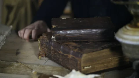 Man at old table, around old books and ritual things Video stock 143110400