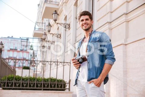 Man with old vintage photo camera standing in the city Stock Photos