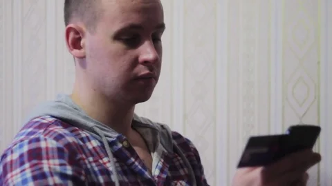 Man online banking using smartphone shopping online with credit card at home Stock Footage 70899213